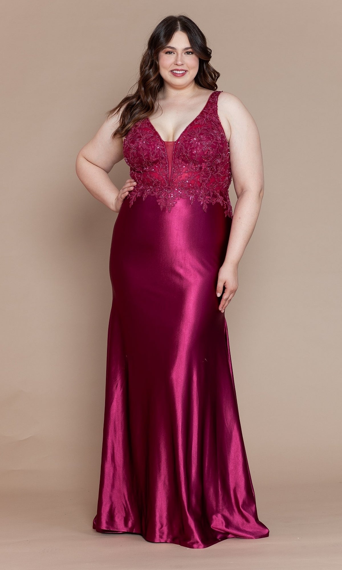 A woman stands in a cherry red Embroidered-Bodice Plus-Size Long Prom Dress W1160, featuring a sleeveless fitted bodice with lace detailing and a smooth, shiny skirt.